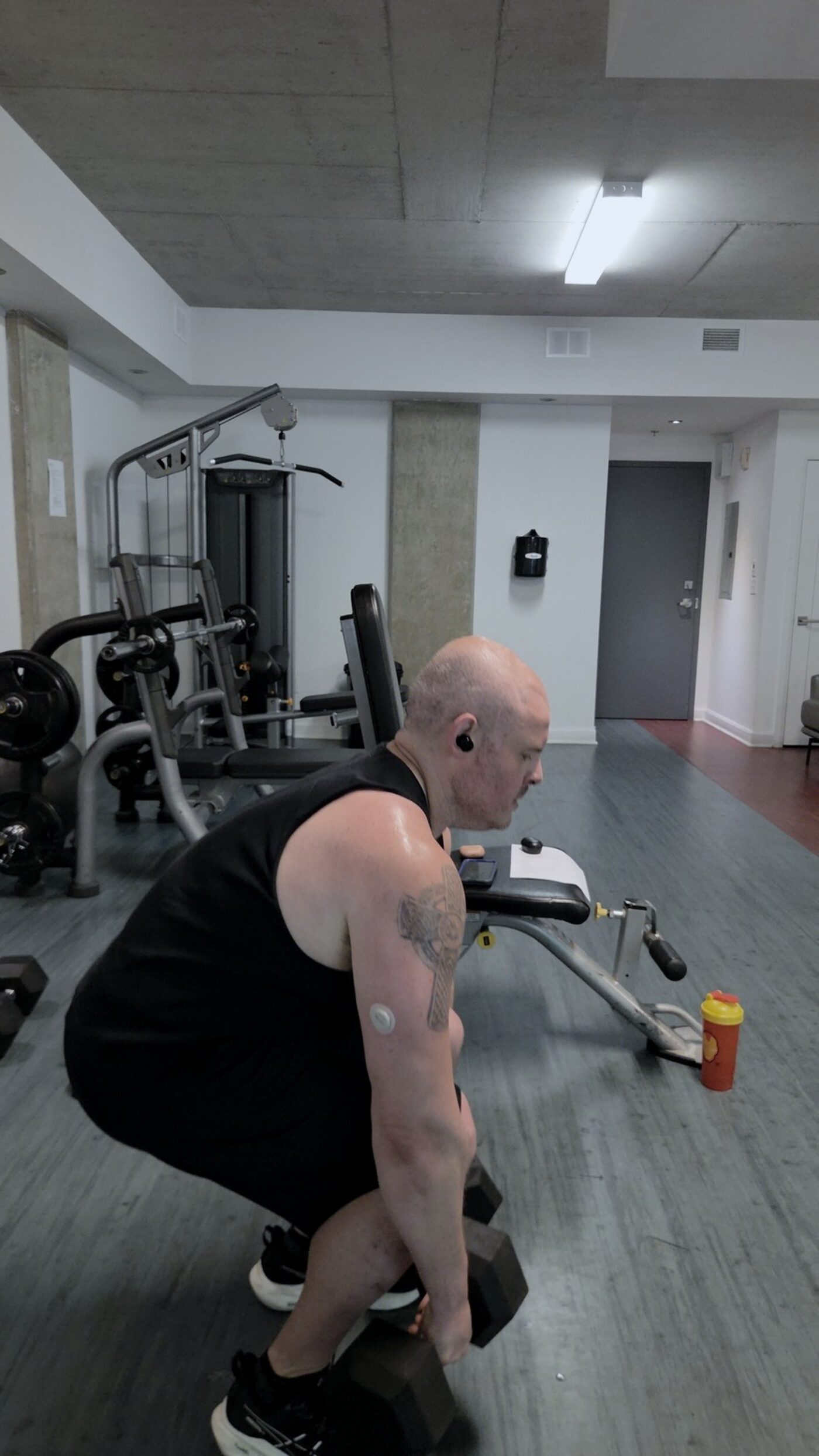 Romanian deadlift with continuous glucose monitor visible on the arm